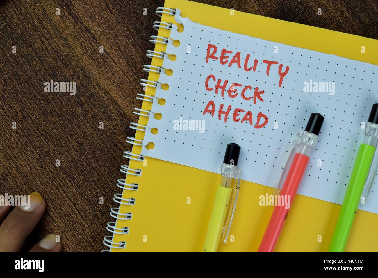Concept of Reality Check Ahead write on sticky notes isolated on Wooden Table. Stock Photo