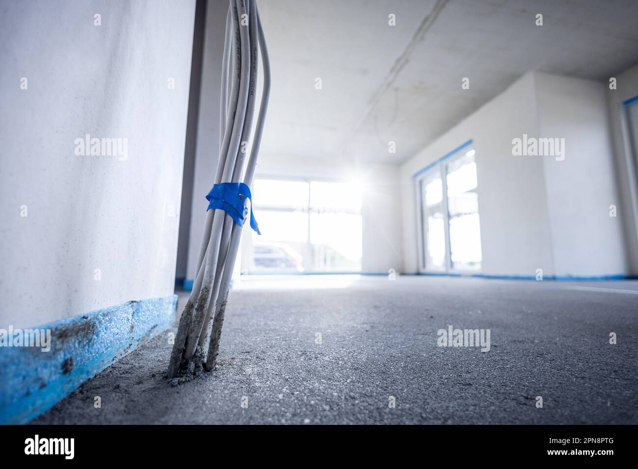 Interior of a building under construction with wiring emerging from the floor Stock Photo
