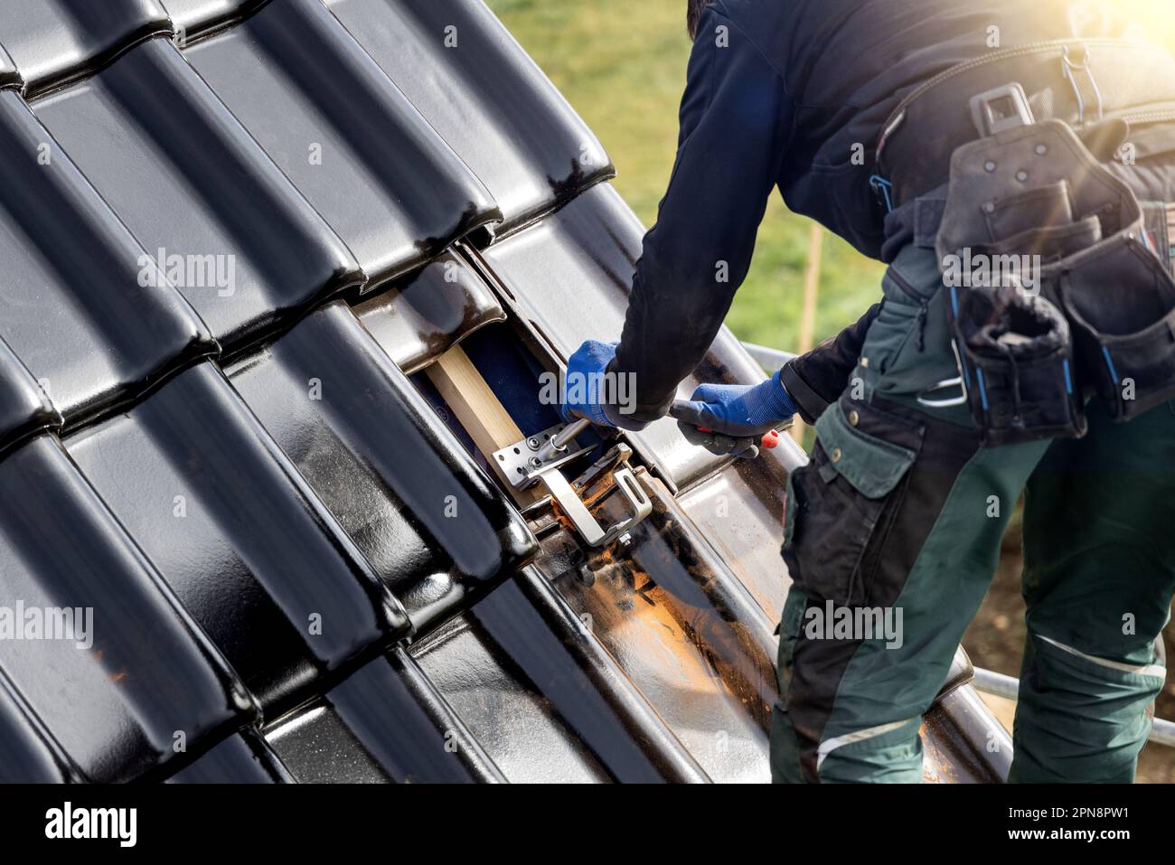 Craftsman fastening a bracket for a solar panel mounting system on a