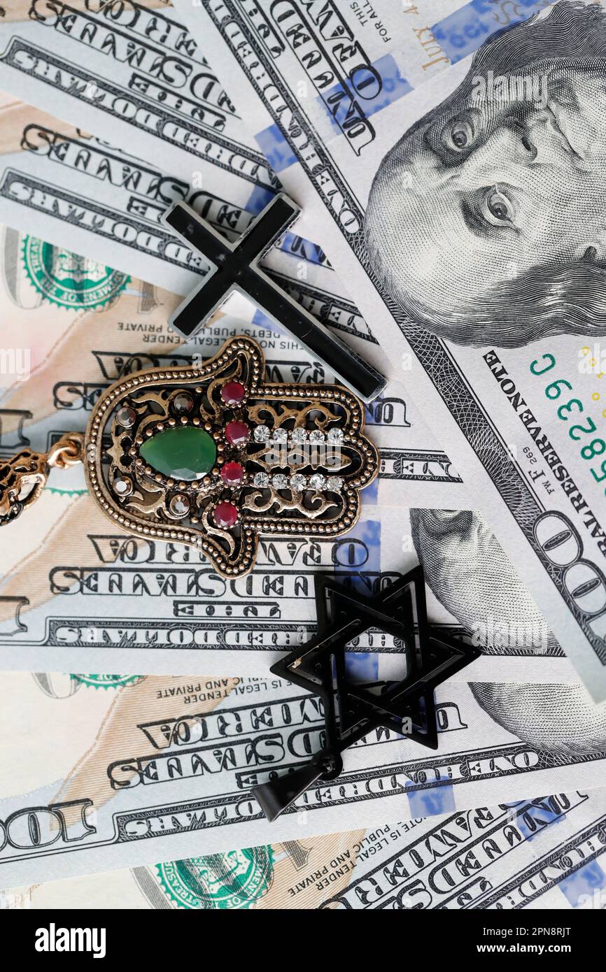 Money, religion and interfaith. Banknotes of US dollars with religious