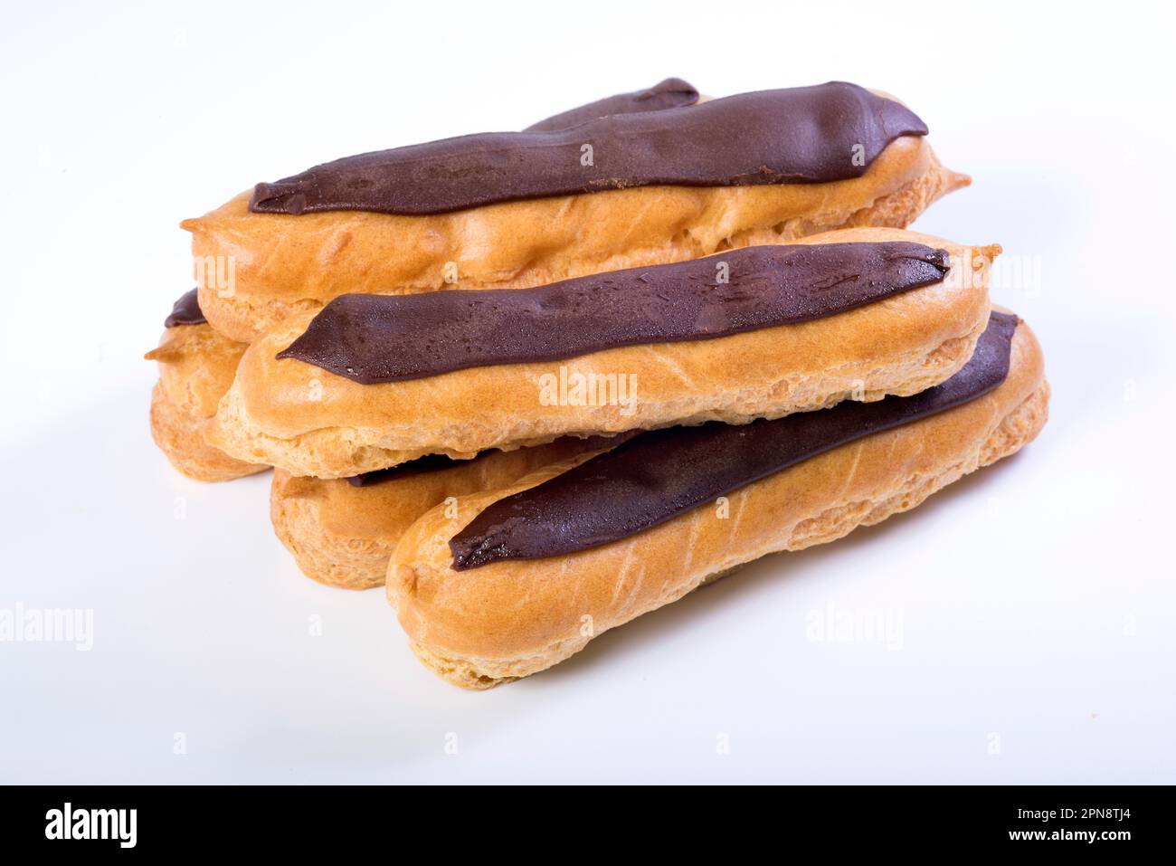 Eclairs with custard inside on a white background. homemade baking Stock Photo