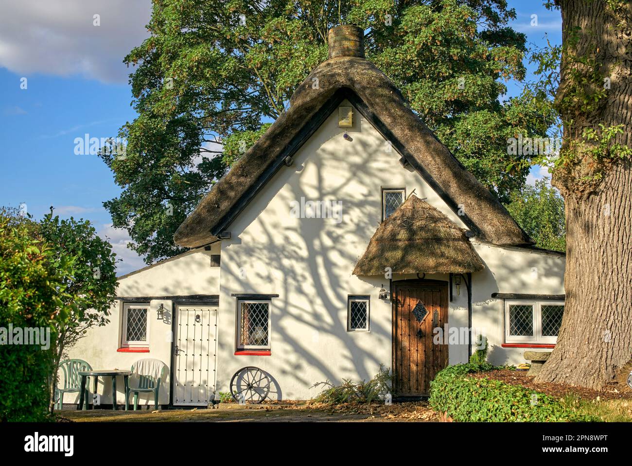 Thatched Cottage UK. Picturesque traditional thatched cottage exterior in an English rural setting. England UK Stock Photo
