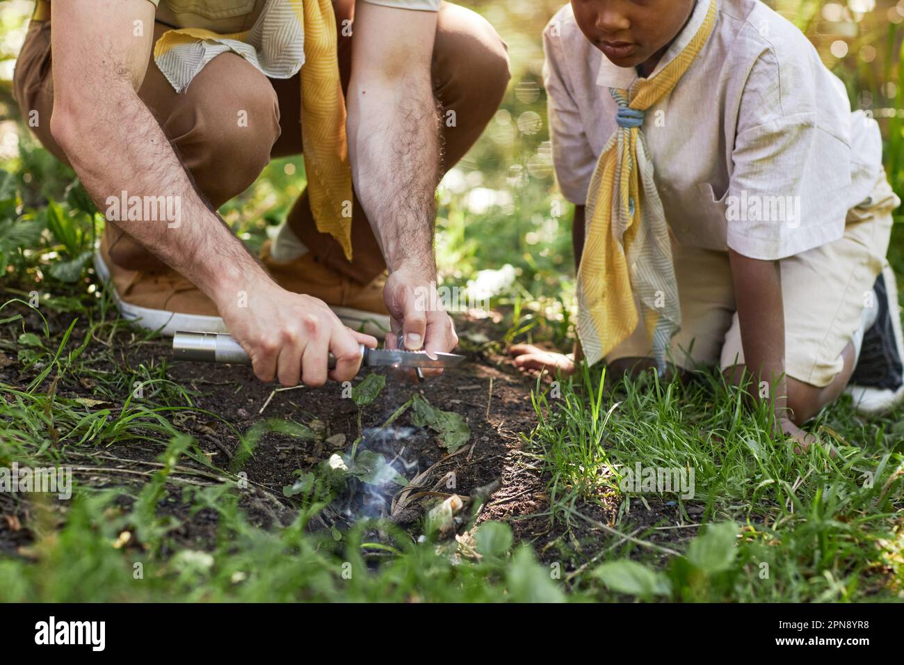 Man Scouting Closeup of adult man as scout leader teching little boy starting ...
