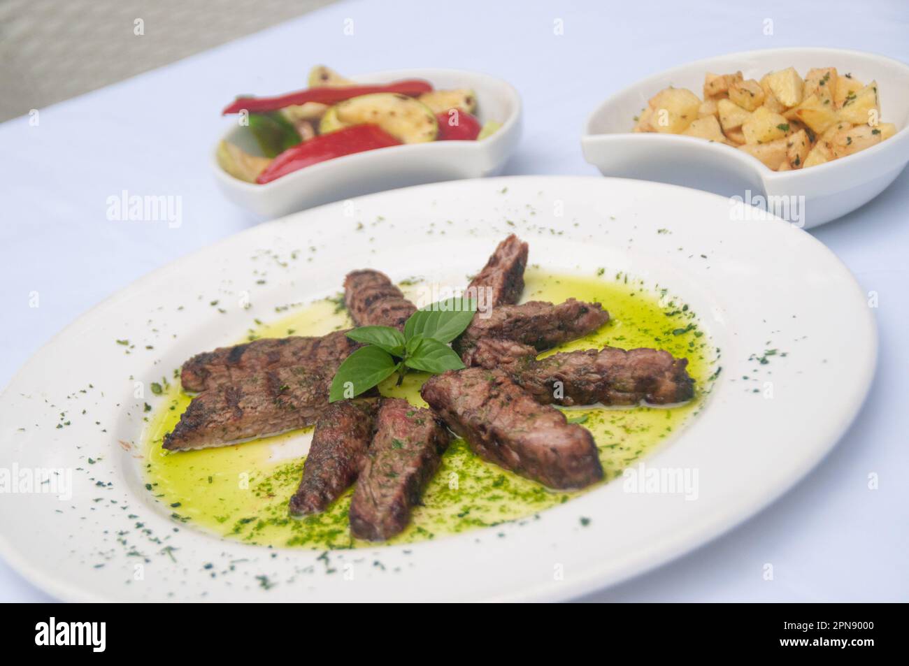 Steak with basil sauce Stock Photo Alamy