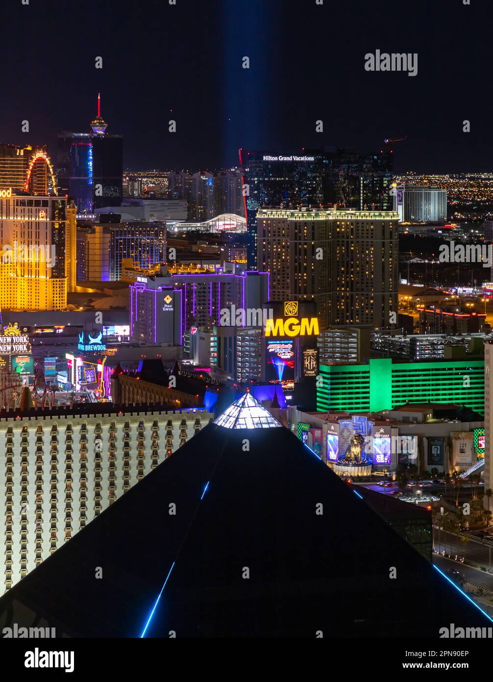 A picture of the Las Vegas Strip at night, with the top of the pyramid of the Luxor Hotel and Casino on the bottom. Stock Photo