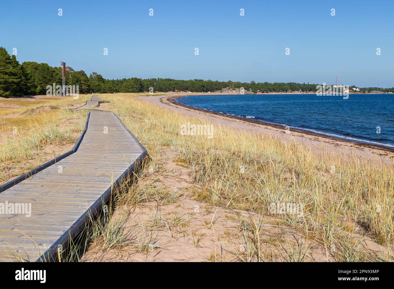 Wooden boardwalk at the Tulliniemi beach in Hanko, Finland, on a sunny day in the summer. Stock Photo