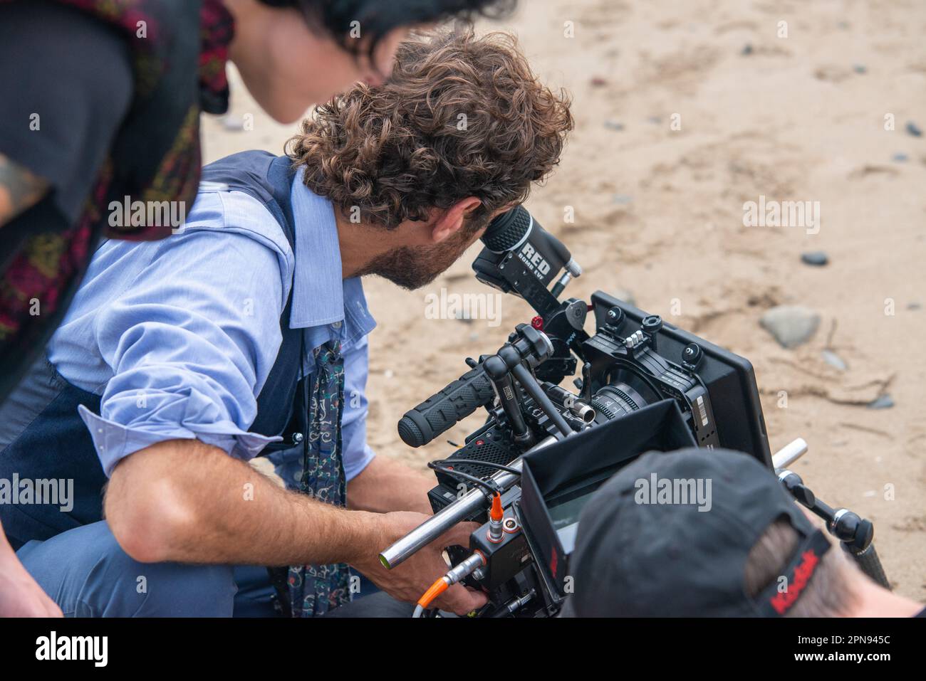 Film crew on coastal location using RED camera Stock Photo - Alamy