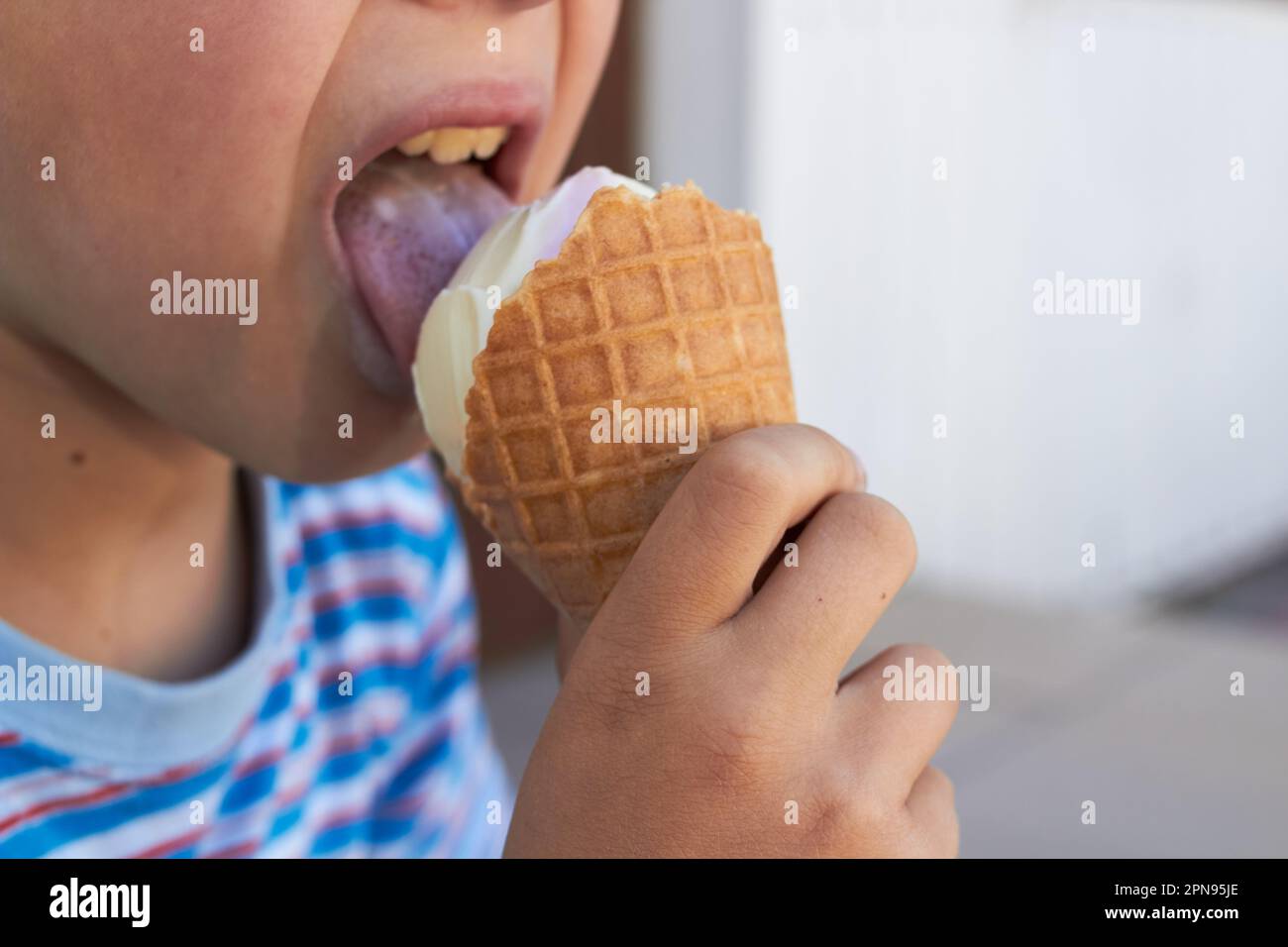 boy licking carob ice cream close up Stock Photo - Alamy