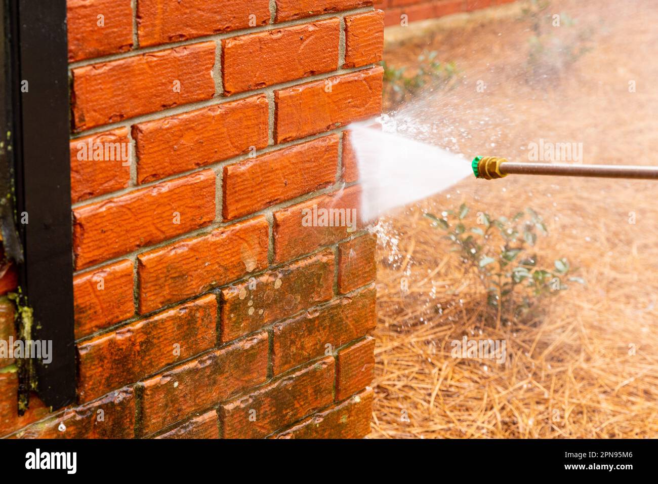 Pressure washer using water to clean a dirty brick wall on a house Stock Photo Alamy