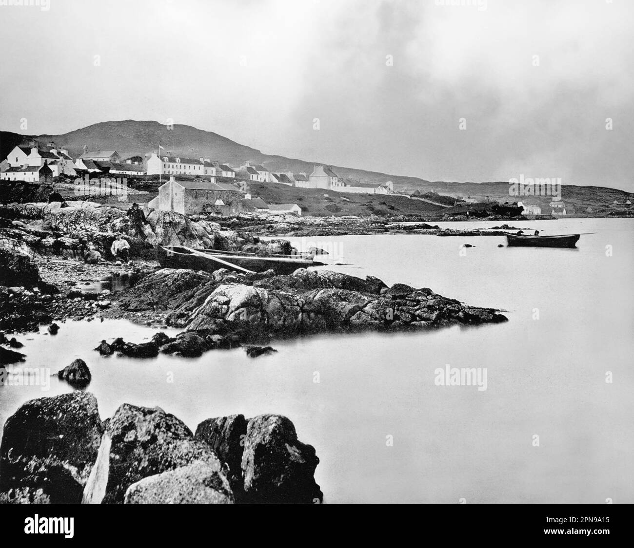 A late 19th century view of Roundstone, a village on the west coast of Ireland, in the Connemara region of County Galway. Roundstone was established by Scottish engineer Alexander Nimmo in the 1820s, while building houses, roads and harbours throughout the West of Ireland. Fishermen from Scotland settled here, and in 1835 a Franciscan Monastery was built. By the end of 1840s it had a thriving fishing industry and a population of 400 people. Stock Photo