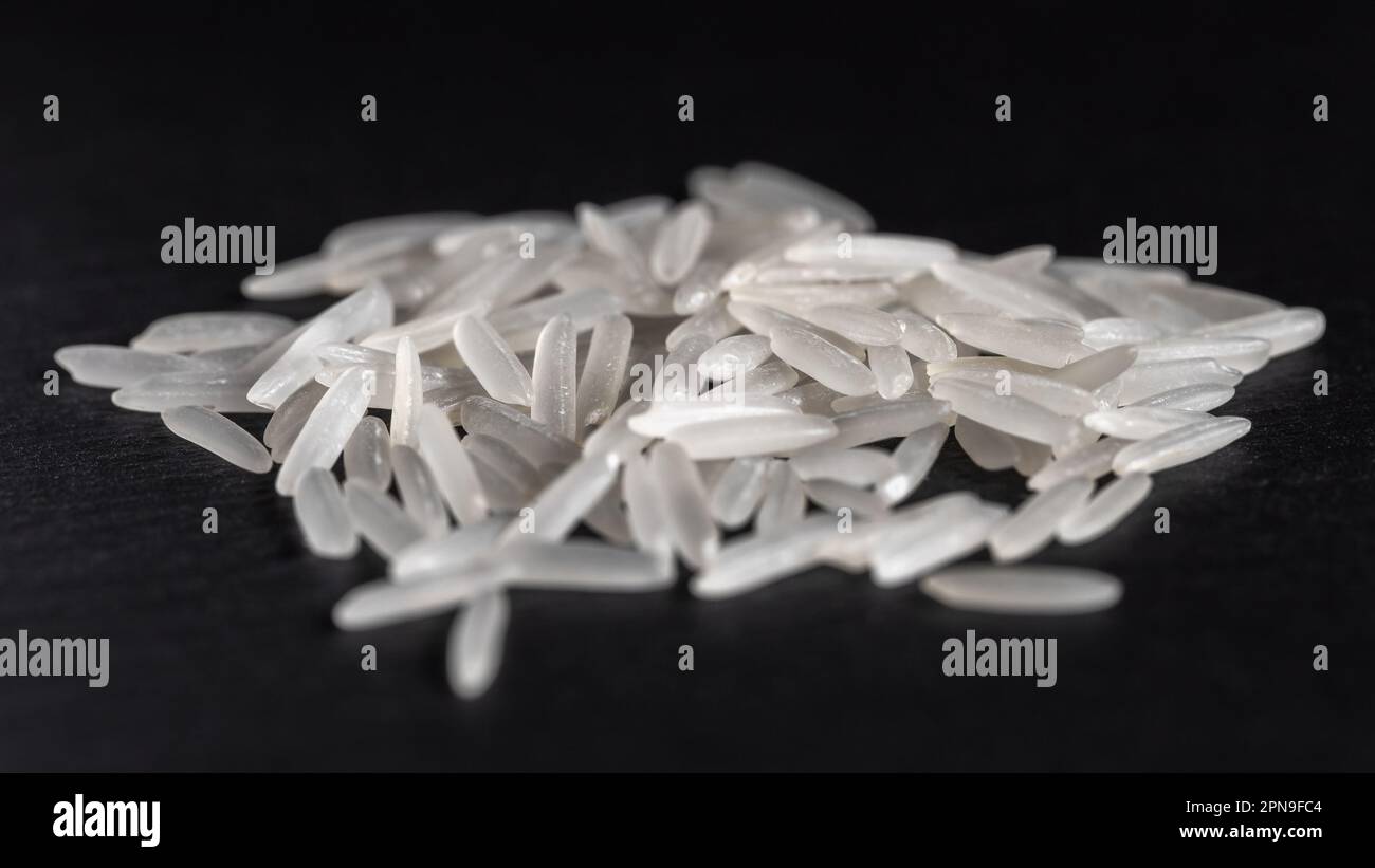 White rice on a black graphite stone slab, healthy food Stock Photo - Alamy
