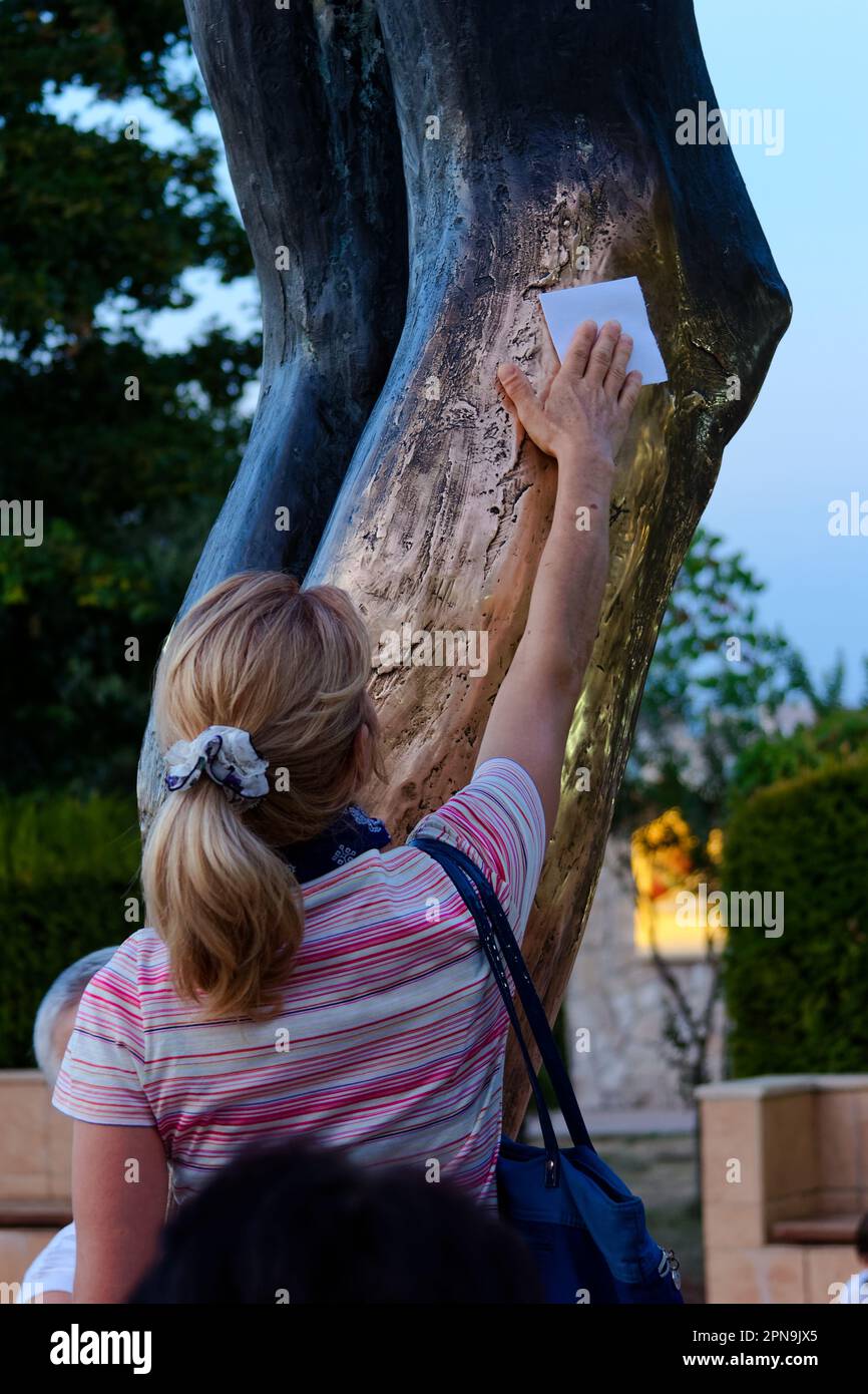 People venerating the statue of the Risen Christ in Medjugorje. The