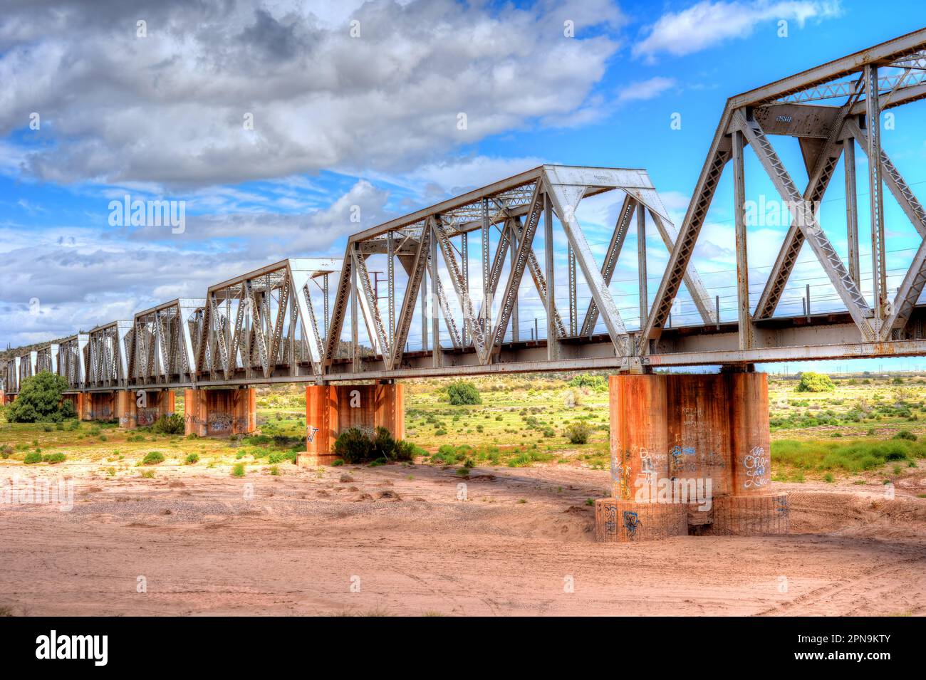 Iron railroad bridge over dry river bed Stock Photo Alamy