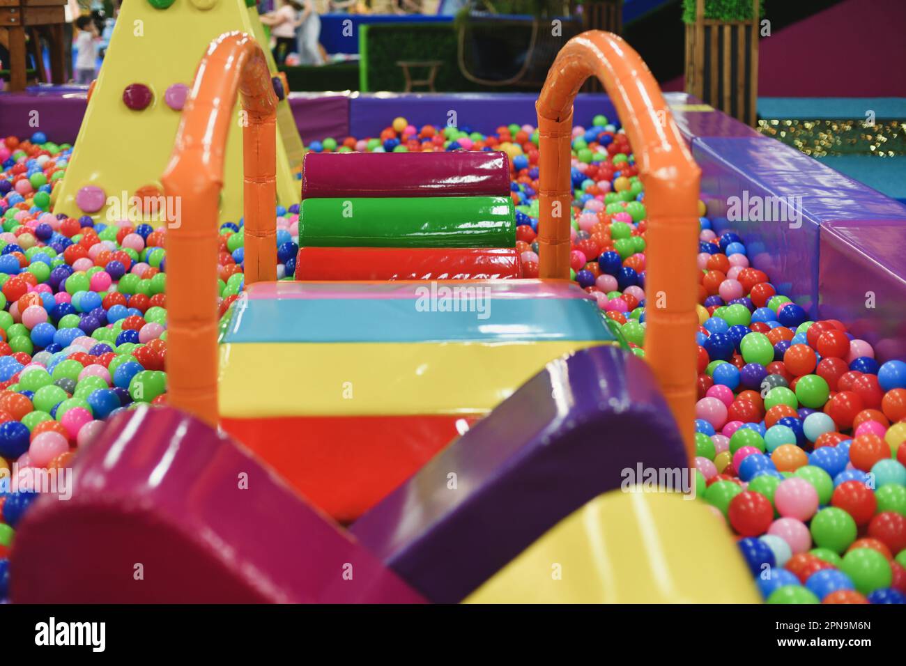 A dry paddling pool in playing centre with balls Stock Photo Alamy