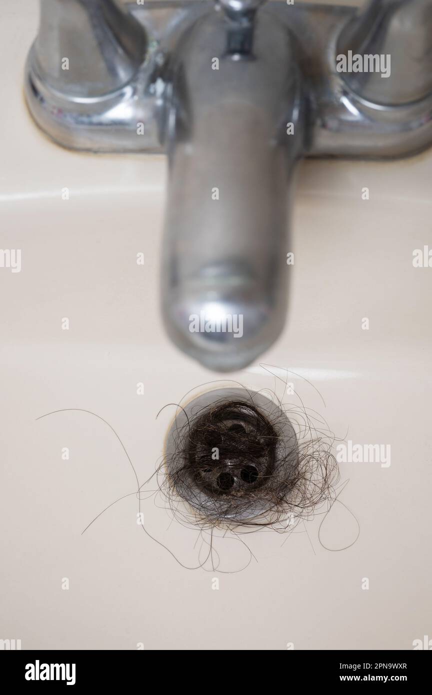 Blocked bathroom metal sink hole with clogged hair above top view Stock ...