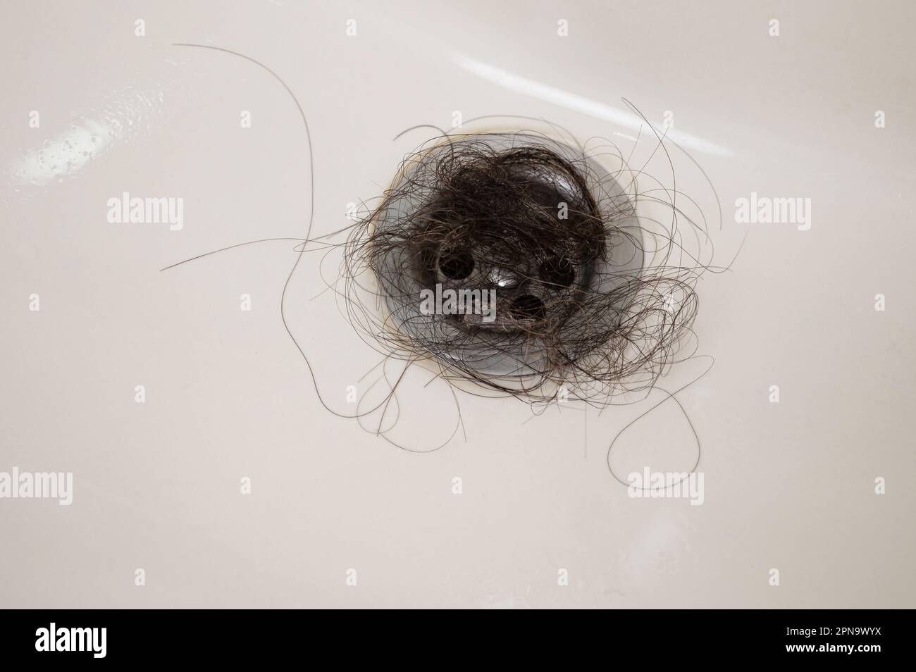 Clogged hair on bathroom sink  macro close up view Stock Photo