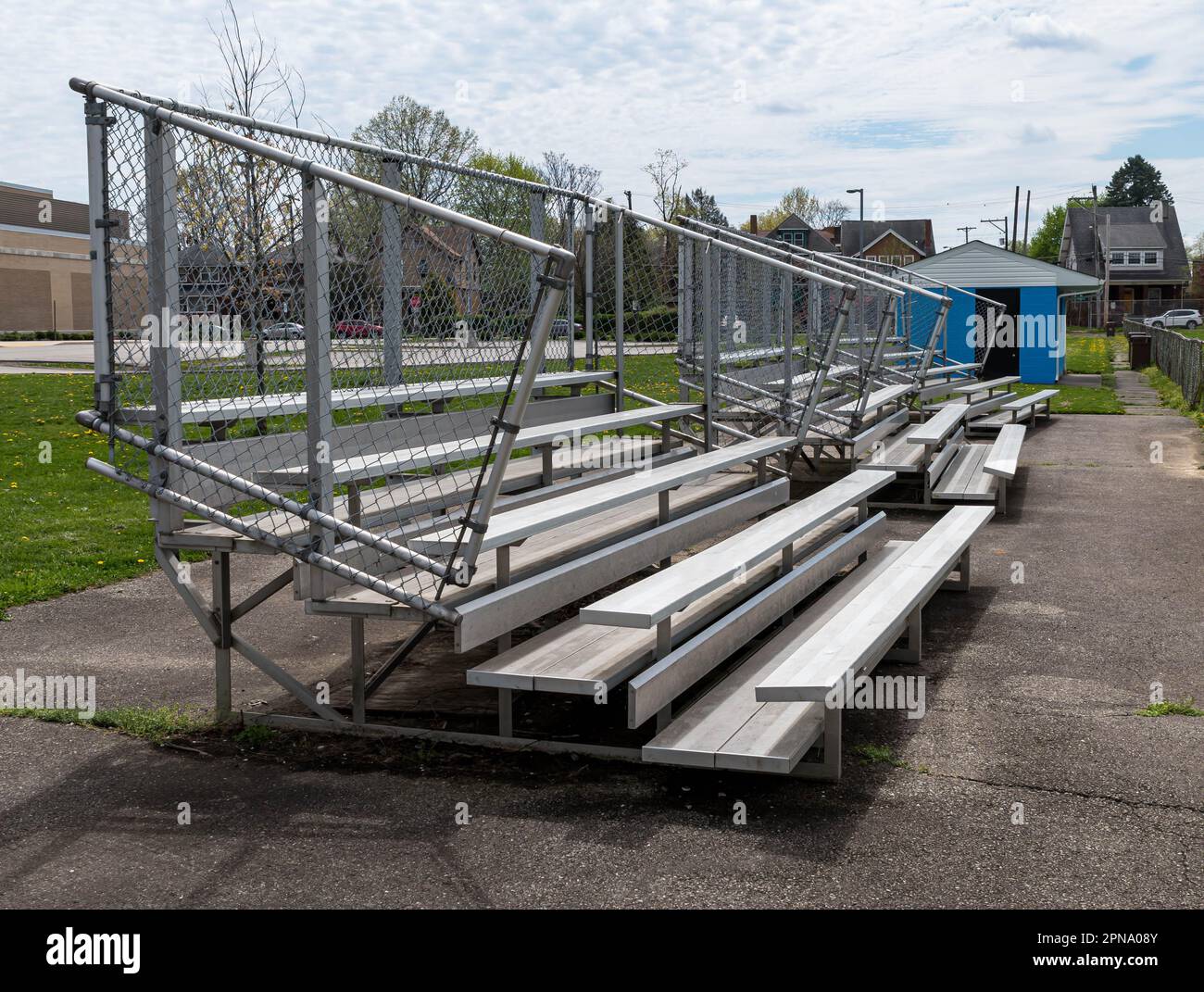 Metal bleachers and a refreshment stand next to a field in Swissvale
