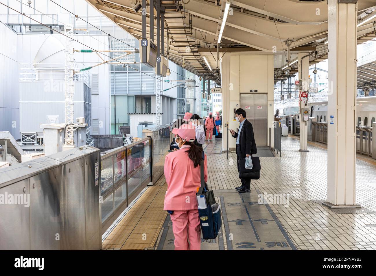 April 2023, female cleaners in uniform wait to board a bullet train Shinkansen at Tokyo station to clean and prepare the train for customers,Japan Stock Photo