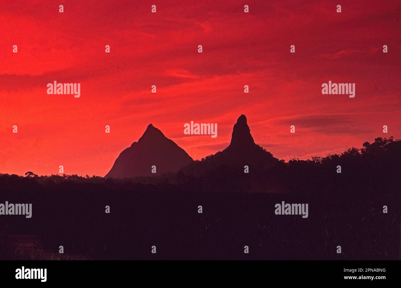 Sunset behind the Glasshouse Mountains, Queensland, Australia of Mount Beerwah and Mount Conowrin Stock Photo