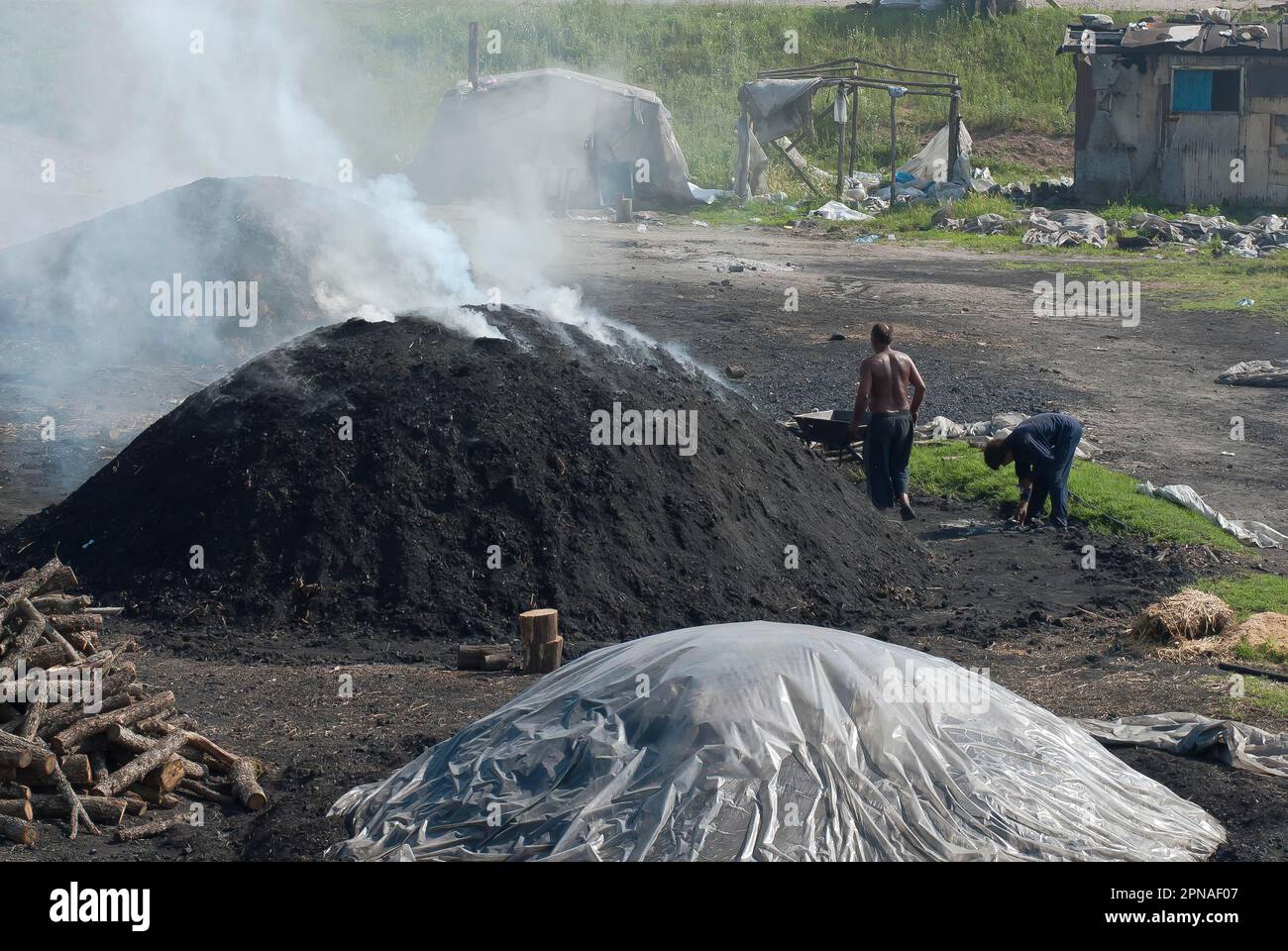 Charcoal burners during charcoal extraction, Ostrodopen, Bulgaria Stock