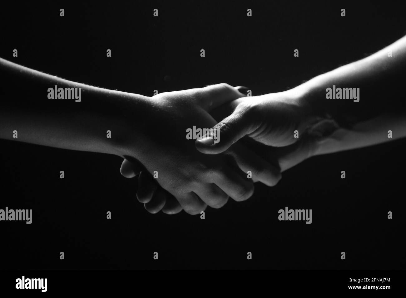 Hands gesturing on black background. Giving a helping hand. Support and