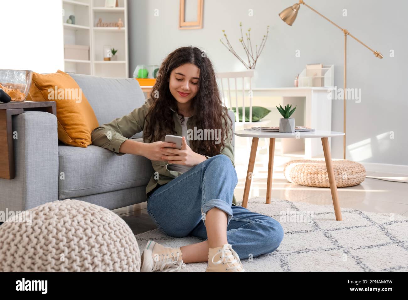 Teenage girl using mobile phone at home Stock Photo - Alamy
