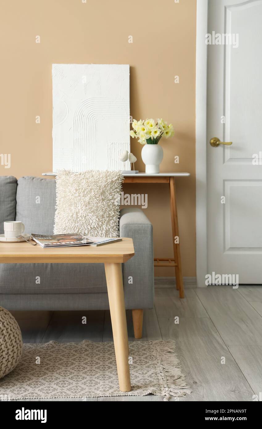 Interior of living room with grey sofa and tables Stock Photo - Alamy
