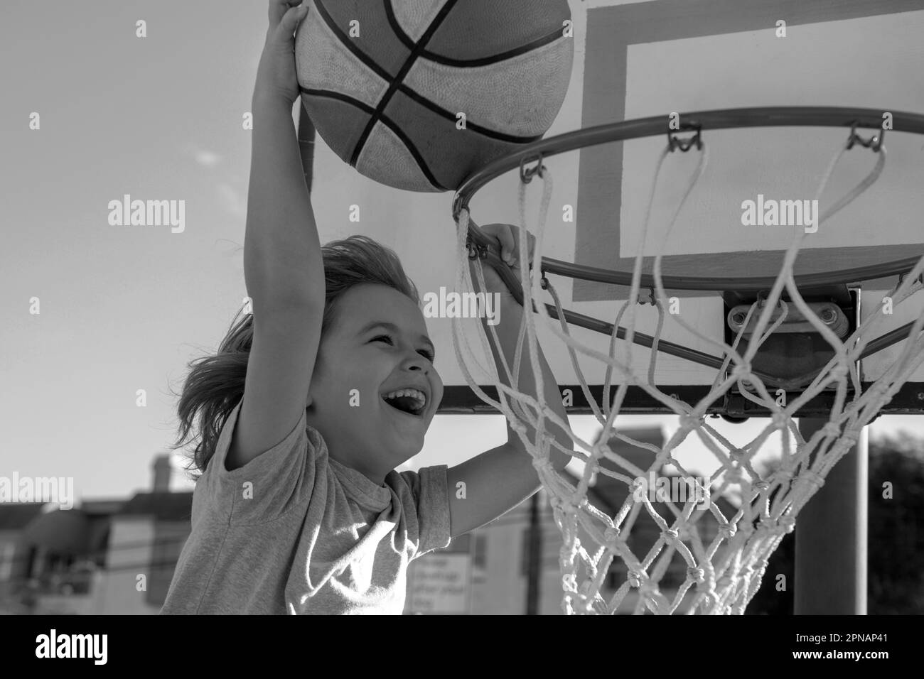 Basketball child player running up and dunking the ball. Active kid ...