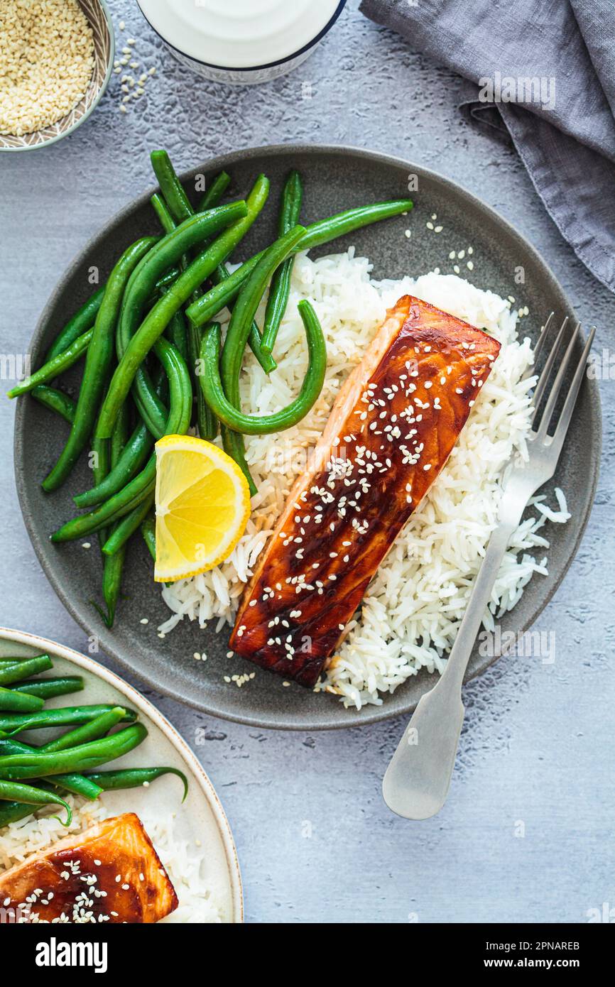 Honey teriyaki salmon with green beans and rice, top view. Asian
