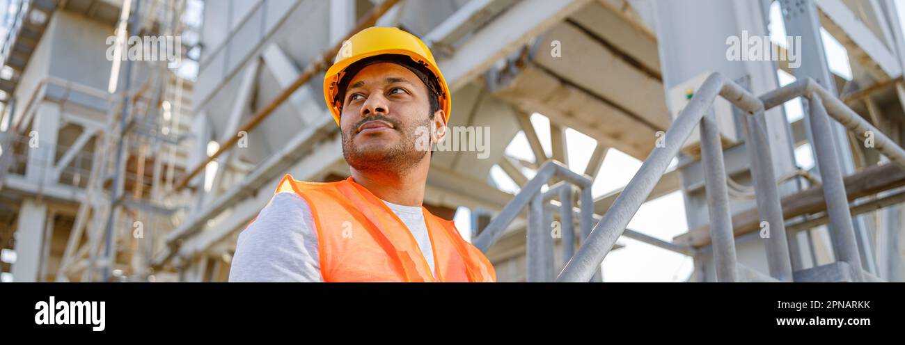 Skillful multiethnic engineer working on construction site Stock Photo