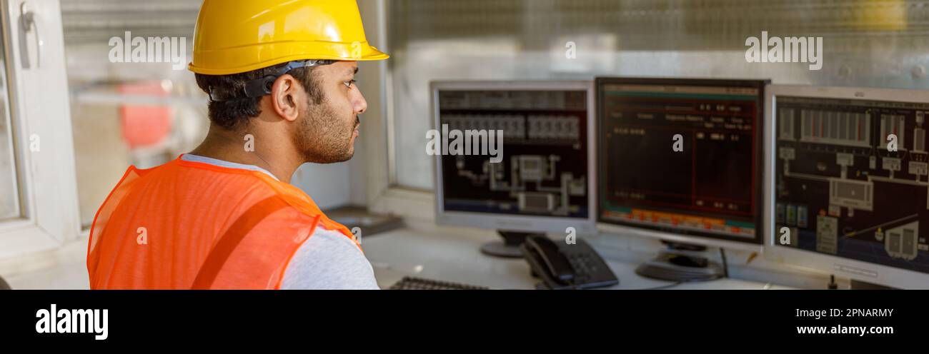 Young multiethnic operator working at concrete plant Stock Photo