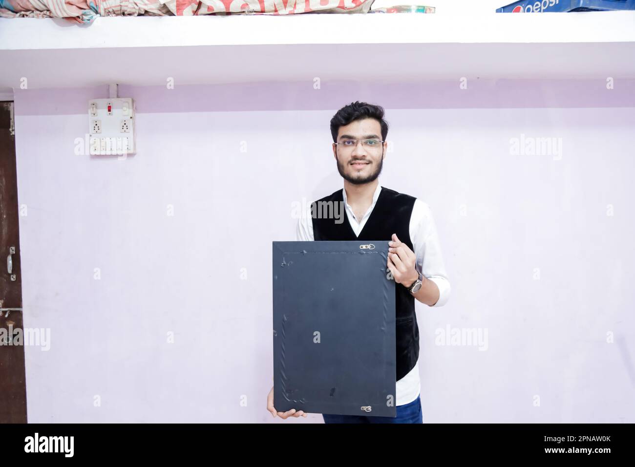 Indian yong smart student holding blank black bord in hands, smart india,  handsome Stock Photo - Alamy