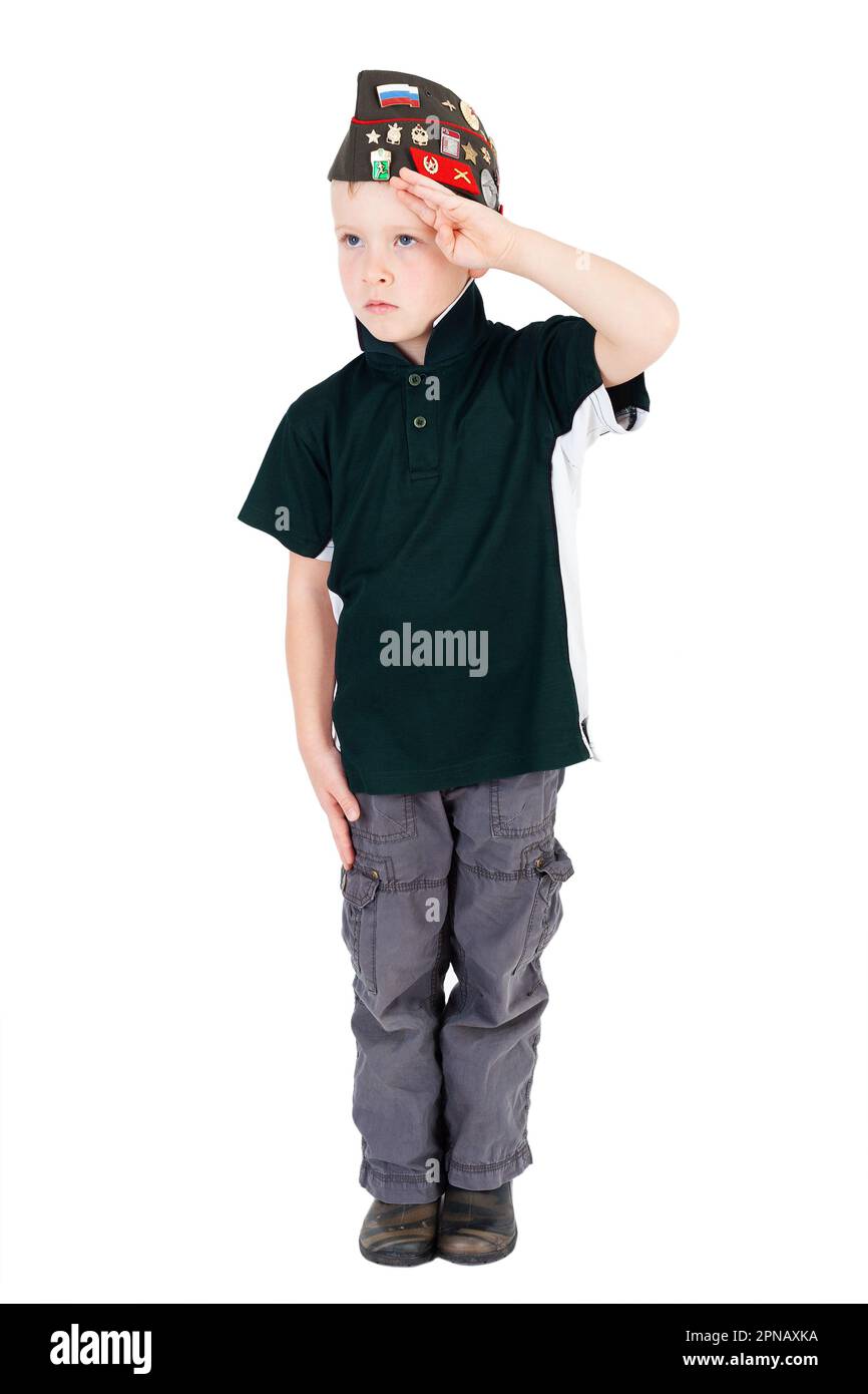 Young caucasian boy saluting looking left playing dressups in green