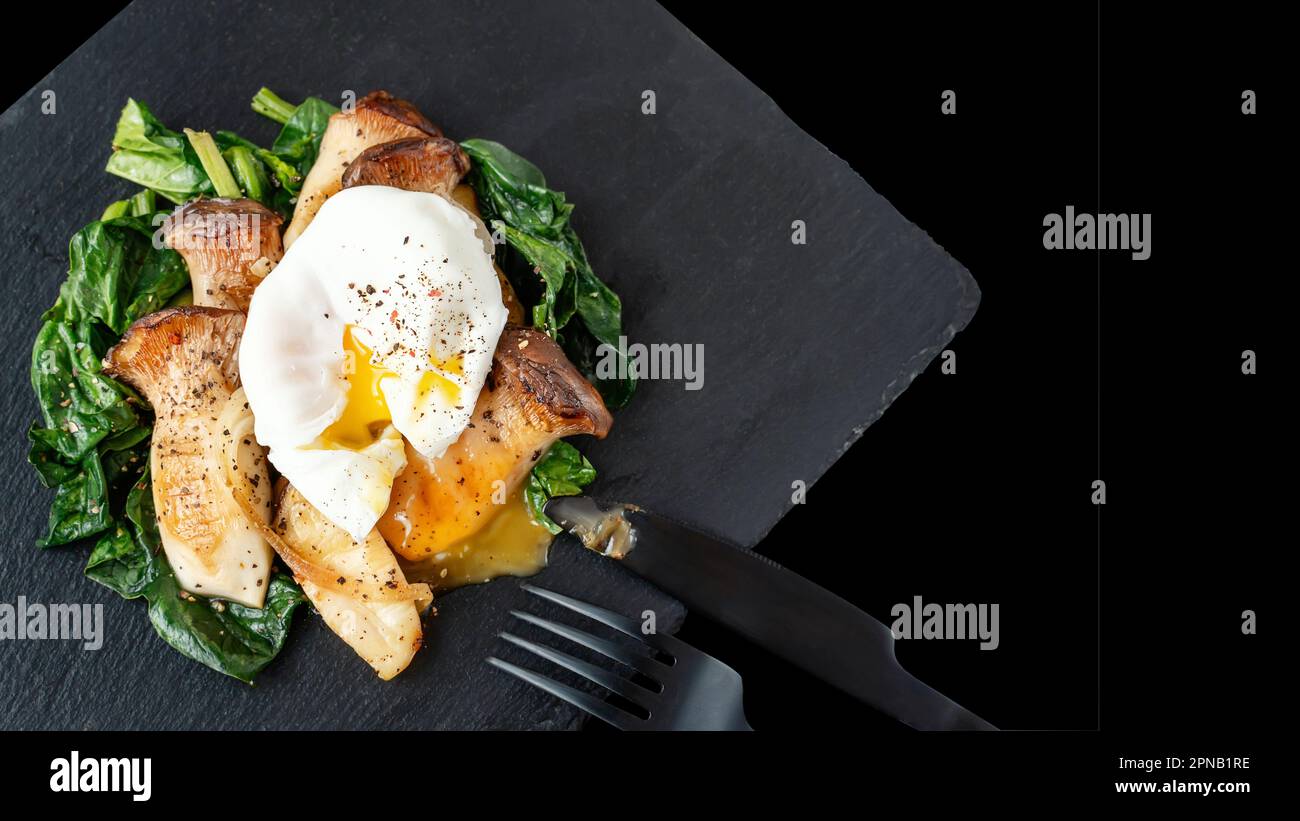 Grilled Pleurotus eryngii mushrooms with poached egg and spinach. Hot