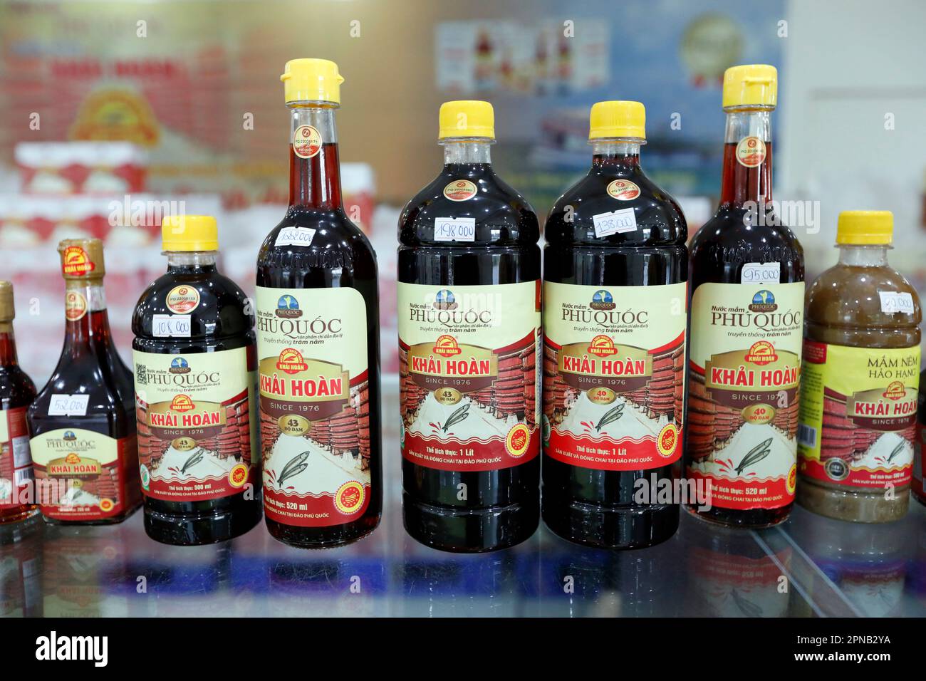 Glass bottles with yellow plastic cap with the traditional Vietnamese fish sauce Nuoc Mam. Phu