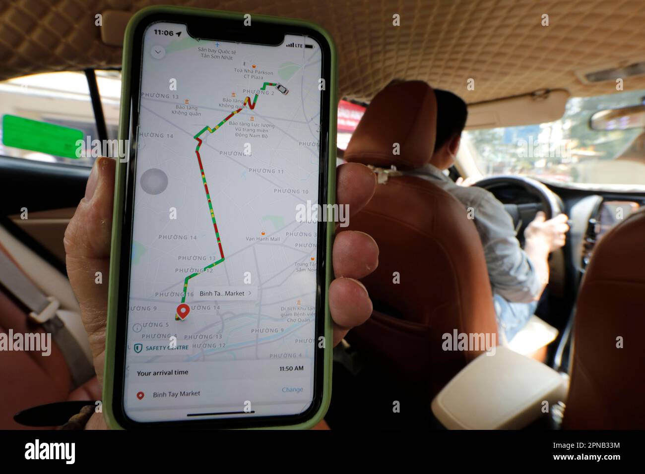 Taxi car Grab app on phone screen.  Ho Chi Minh City. Vietnam. Stock Photo