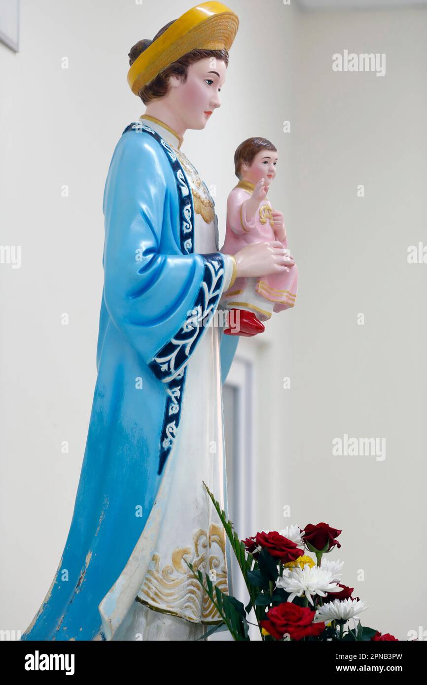 Fatima church.  Statue of Our Lady of La Vang in Ao Dai dress. Virgin and child.  Ho Chi Minh City. Vietnam. Stock Photo