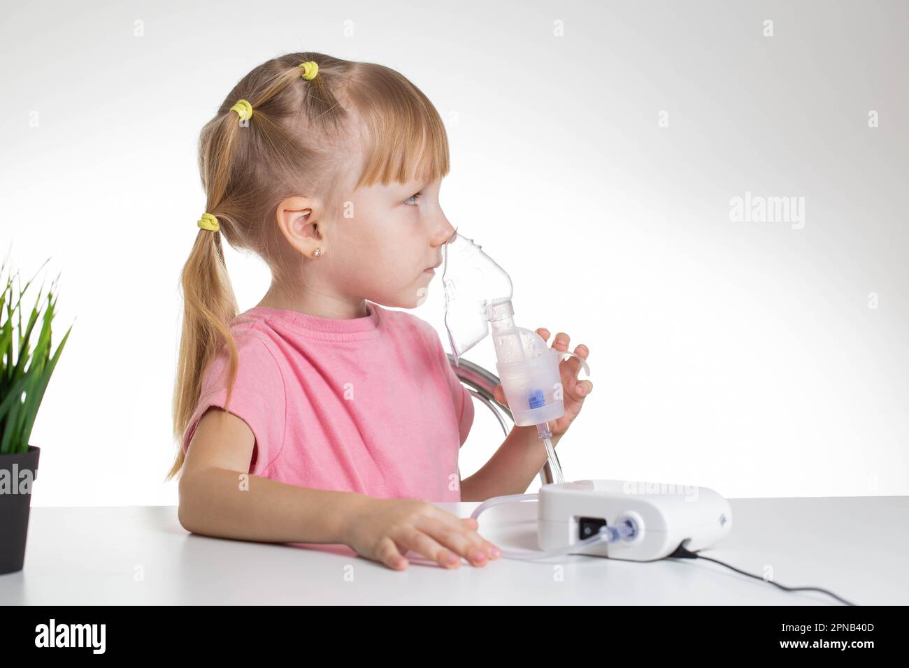 A 5yearold girl is breathing into an inhaler at home. Treatment of