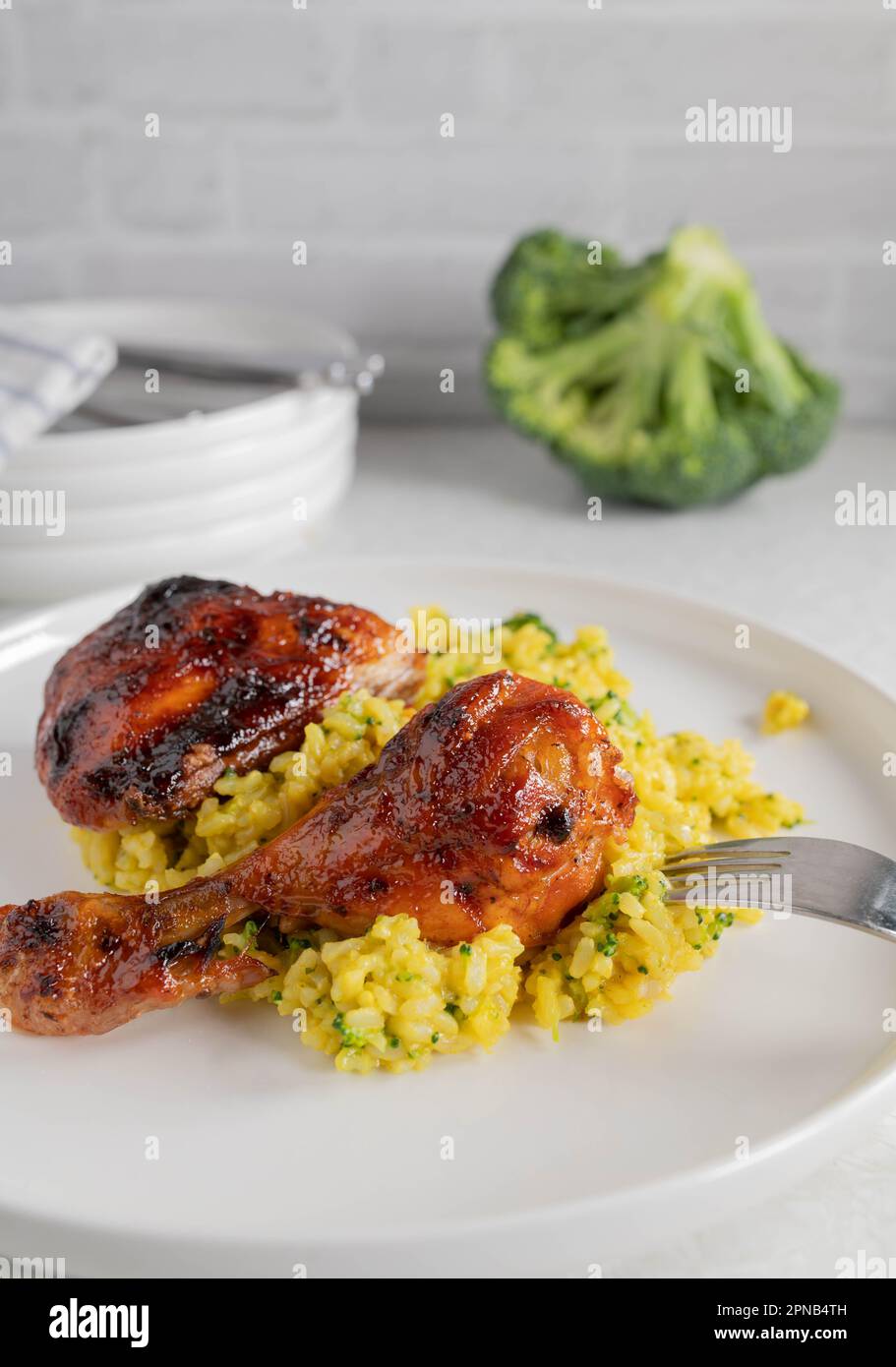 Oven baked and glazed chicken drumsticks with curry, broccoli brown