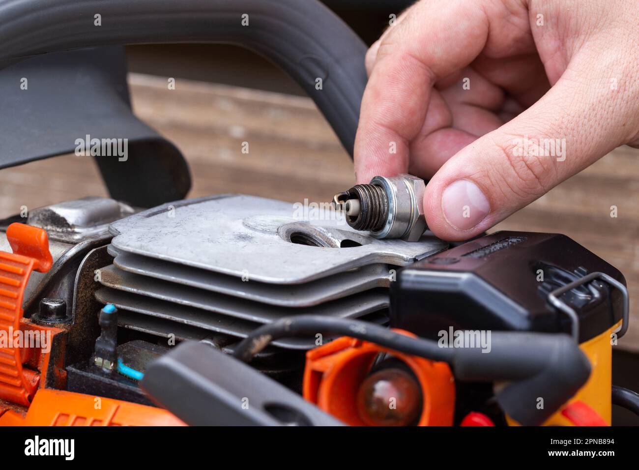 Wet spark plug in a chainsaw. Rich fuel mixture. Malfunction in the