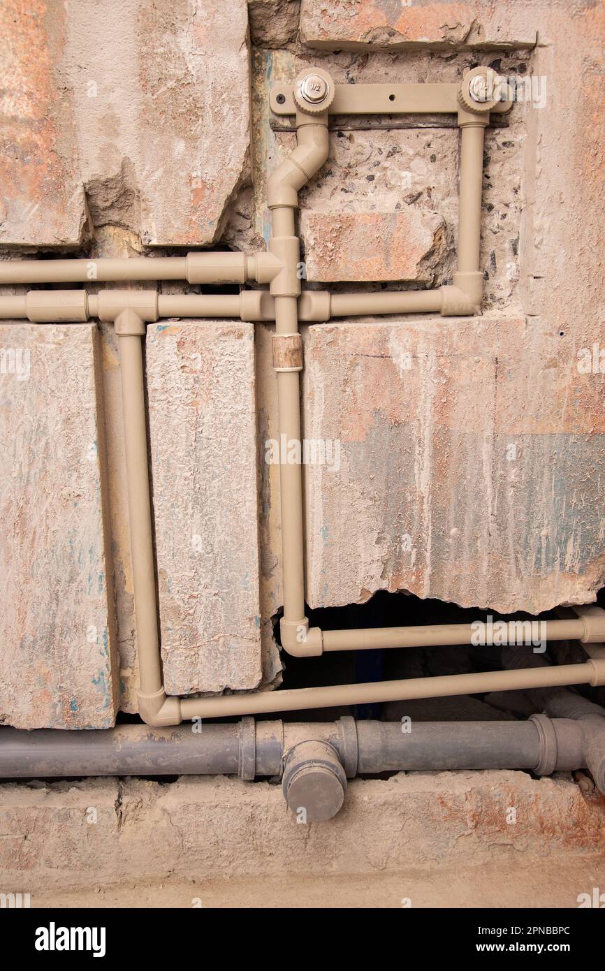 Transfer of water pipes and sewerage drain in the wall. Bathroom plumbing installation Stock
