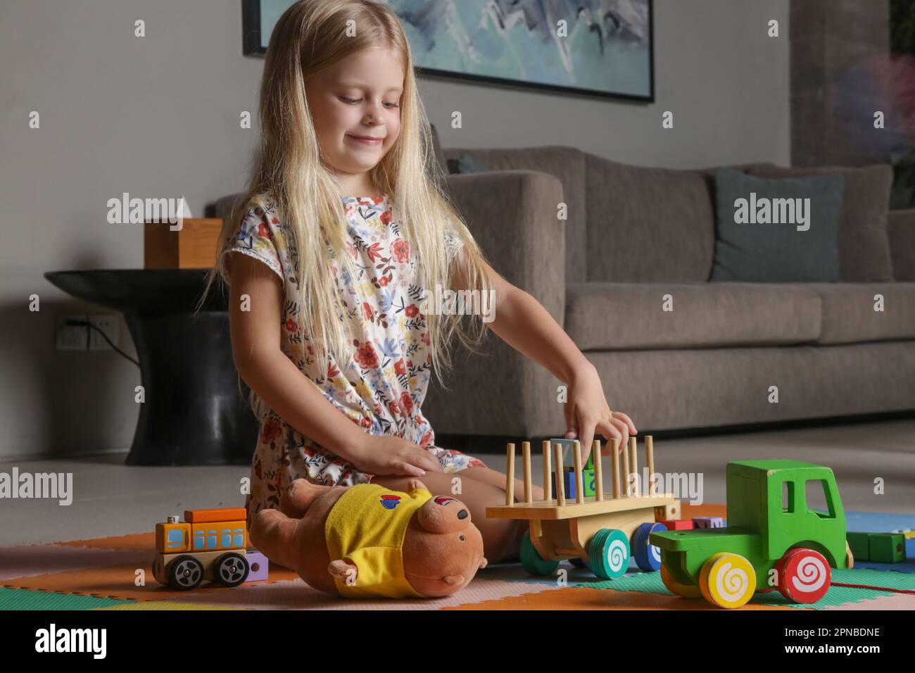 Adorable little girl playing with wooden toys at home Stock Photo - Alamy