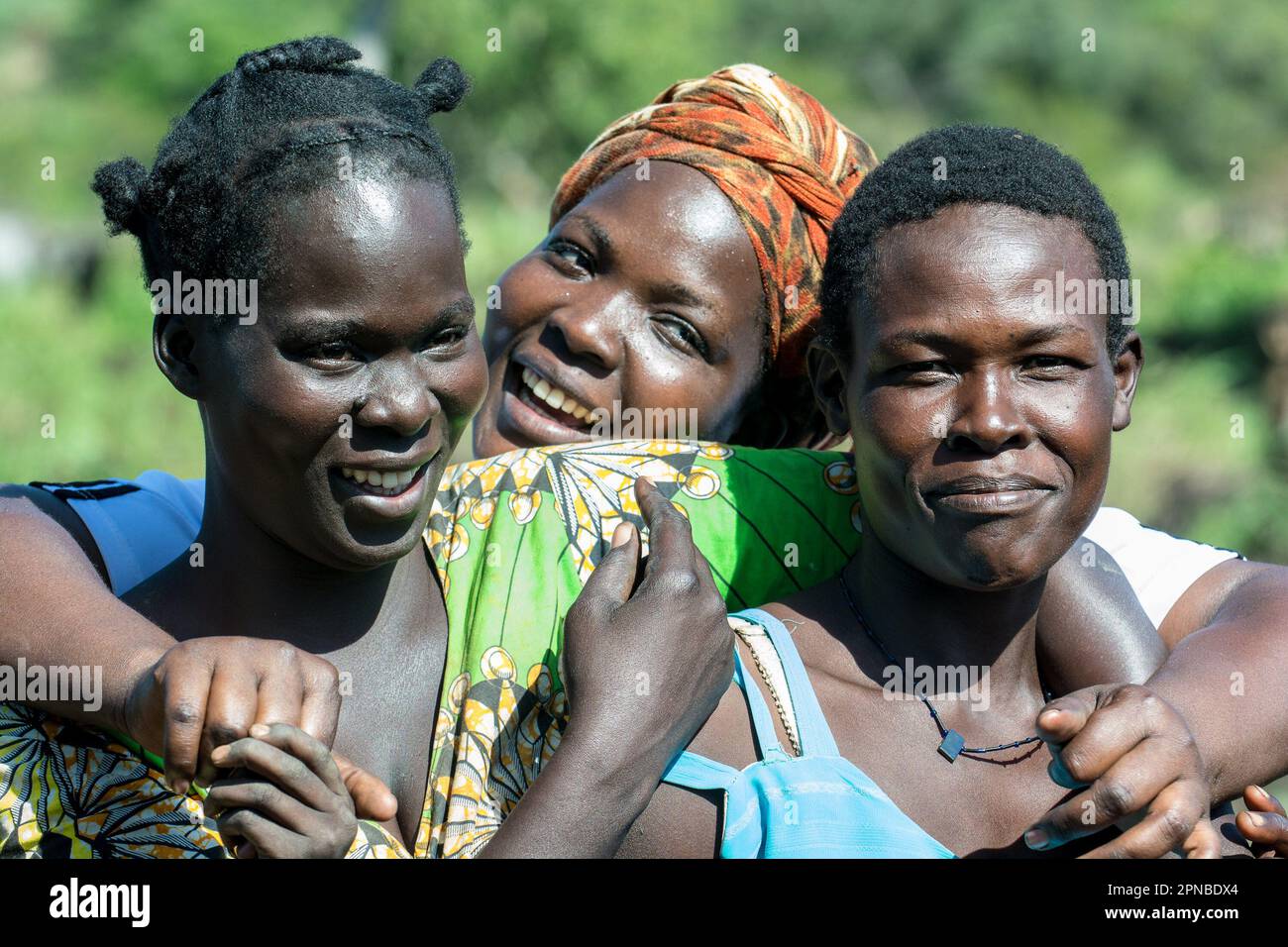Northern Ugandan female celebrity singer Jenneth Prischa in the centre smiles for the camera at her village in Lacara village Padibe, Lamwo district. Uganda. Stock Photo