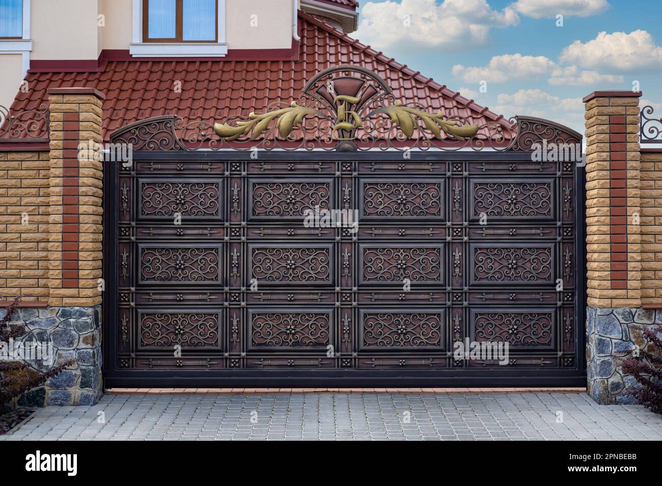Modern strong decorative gates with wrought iron elements near a  residential building Stock Photo - Alamy, image size:1300x956