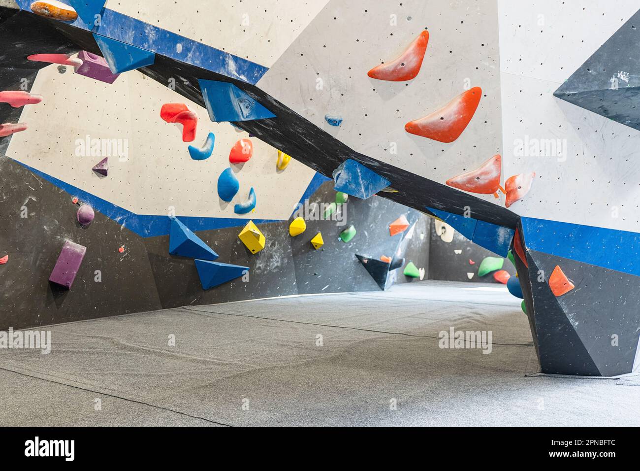 Contemporary indoors climbing gym decorated with polyethylene foams and