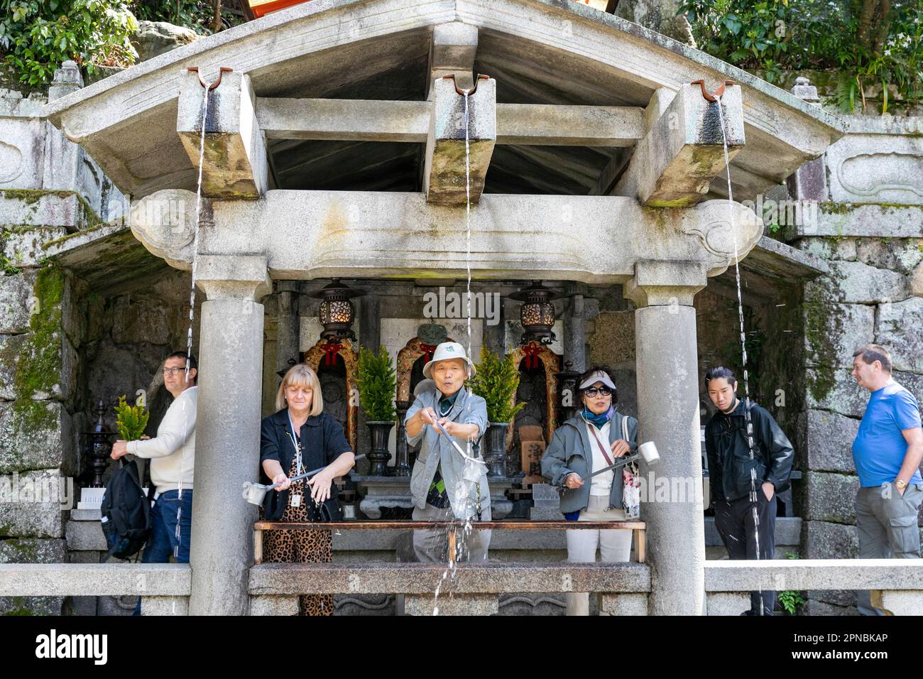 April 2023, Kiyomizu-dera temple in Kyoto,   people drinking from the Otowa waterfall for luck,Japan,Asia Stock Photo