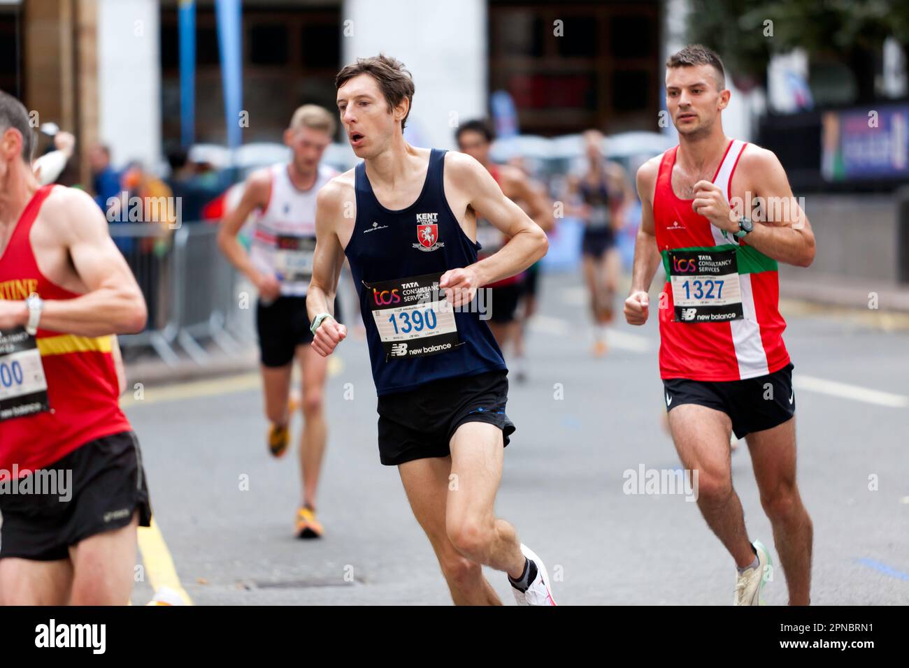 Joe Hartley, of Kent AC, passing through Cabot Square on his way to finish 45th in the 18-39 Category, of the 2022 London Marathon in 02:29:14 Stock Photo