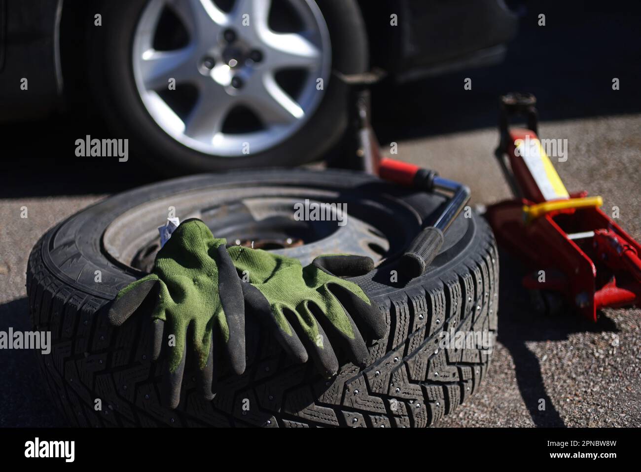 Someone changing wheels, from winter tires to summer tires Stock Photo