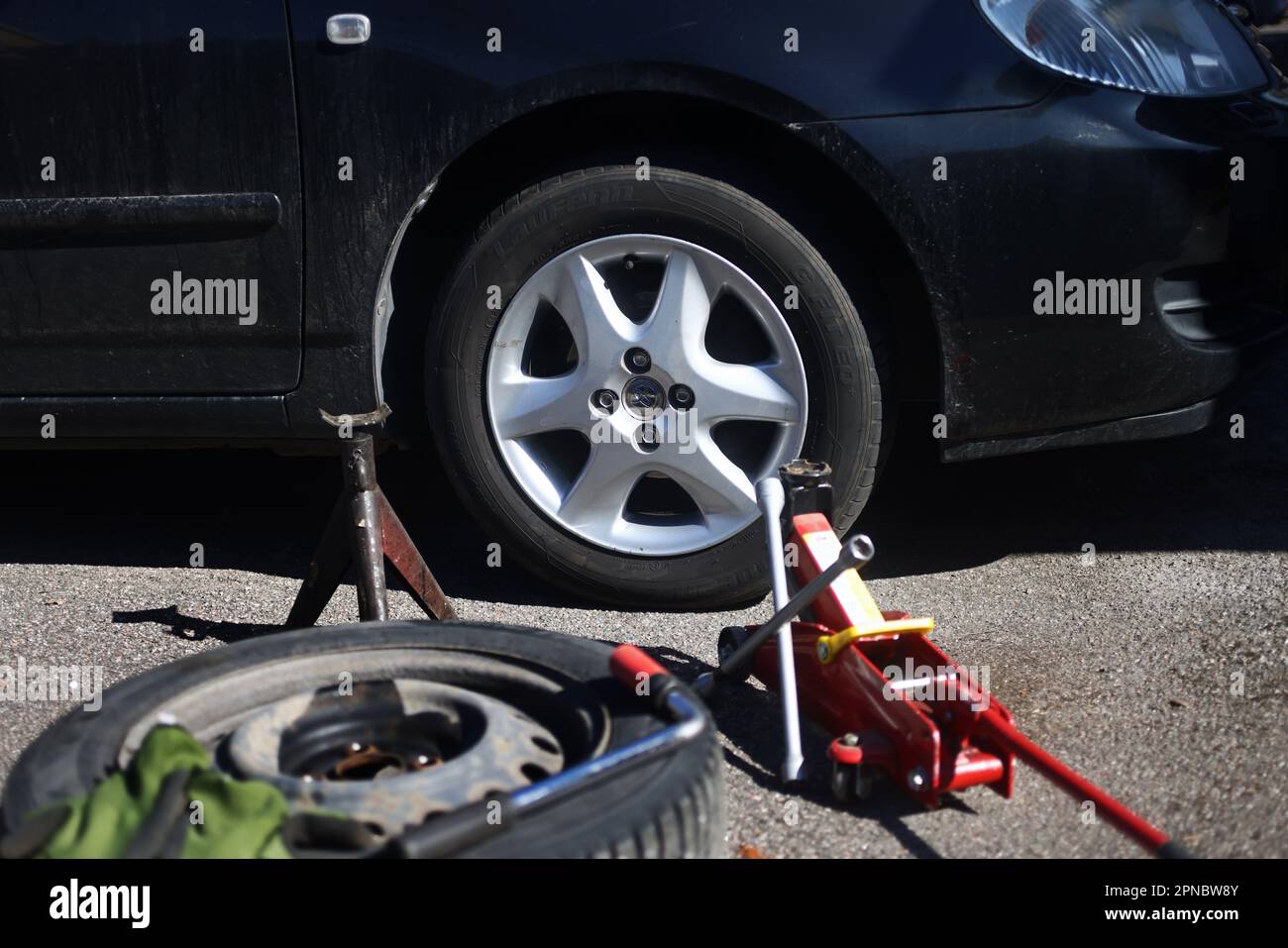 Someone changing wheels, from winter tires to summer tires Stock Photo