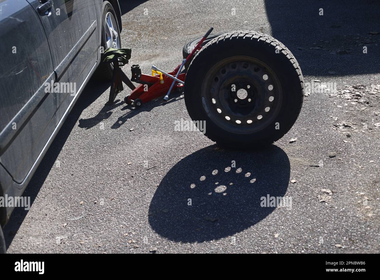Someone changing wheels, from winter tires to summer tires Stock Photo